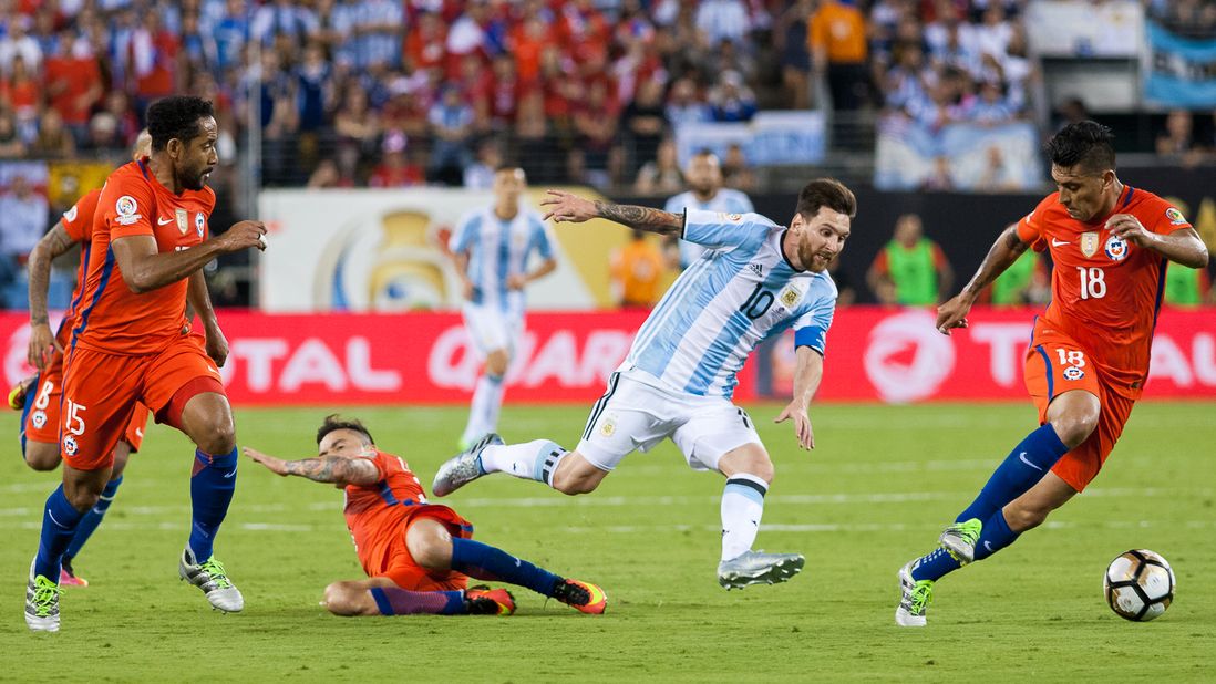 Argentina's Lionel Messi (10) engages a swarm of Chilean defenders.